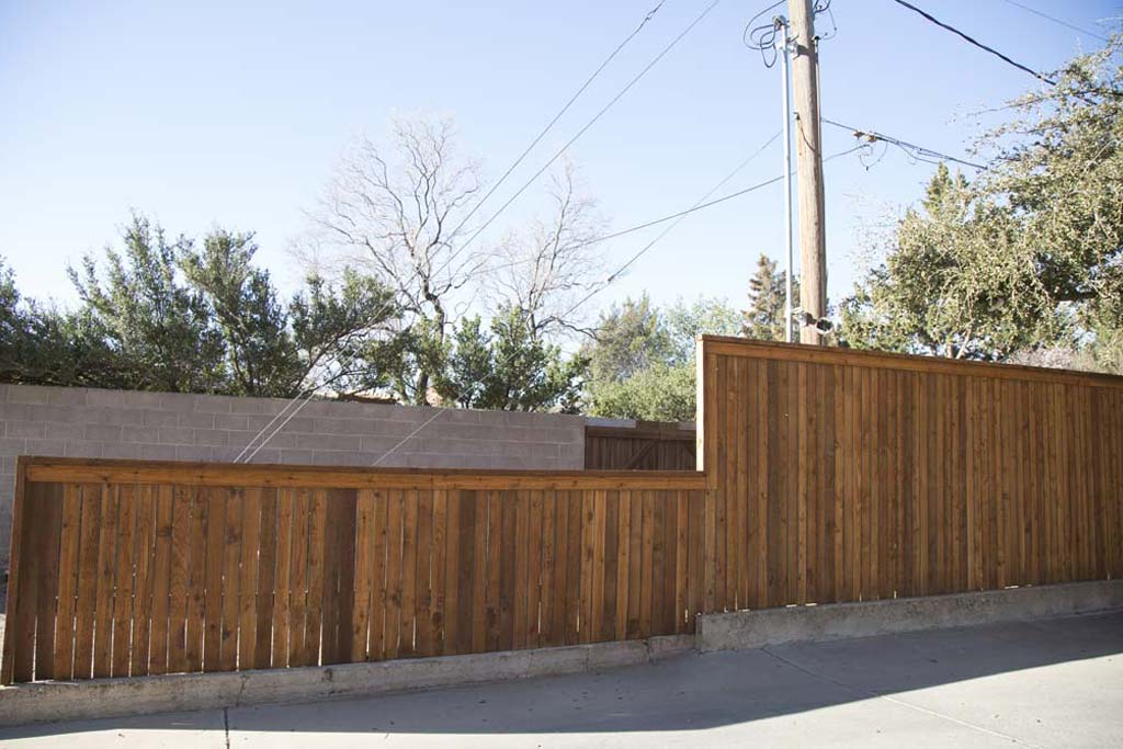 Capped fence with step-down